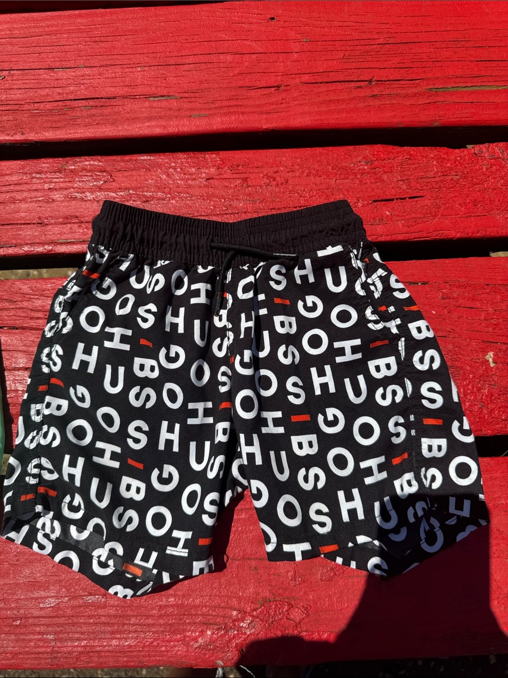 Hugo Boss Black Swim Shorts with White Logo Print and Red Accents